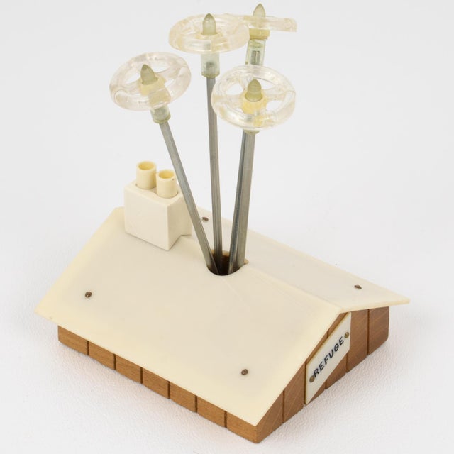 This is a stunning French Mid-Century bar accessory cocktail pick set. That could be where you spent your last vacation in...