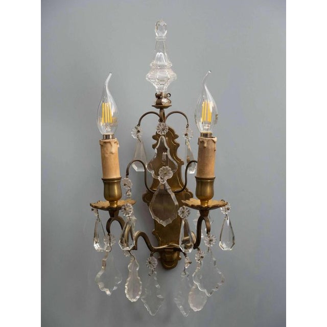 This pair of wall lamps is an excellent example of elegant historical lighting. Made of bronze and decorated with crystal...