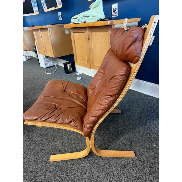 1960s Scandinavian Westnofa “Siesta” High lounge chair and ottoman. Leather detachable cushions with canvas sling. Bent...