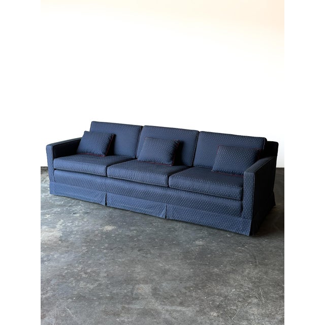 Clean mid-century modern lines meet a deep blue jacquard on this vintage track arm sofa. Low, boxy arms frame the seat,...