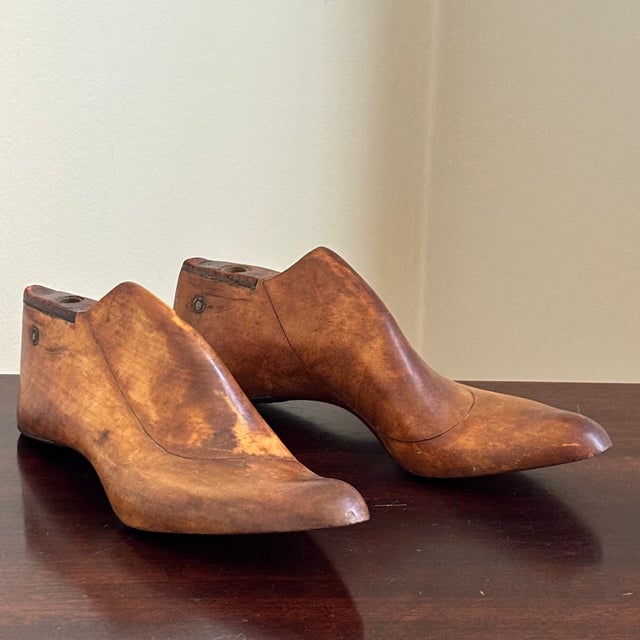 A charming pair of antique wooden shoe lasts dating to the early 20th century. Hand-carved from hardwood and beautifully...