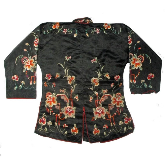 This Antique Chinese silk embroidered jacket dates from the 1900s. It is made of a black silk fabric background, with...