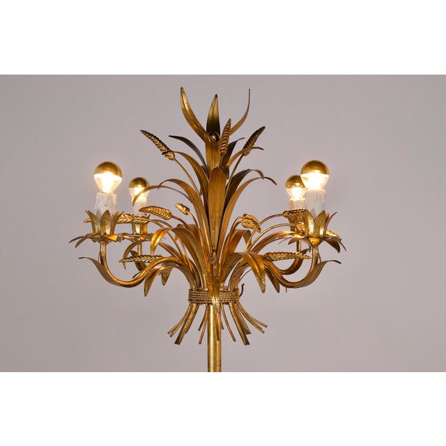 Pair of "wheat sheaf" tripod floor lamps in gilded wrought iron, each with four arms. Italian work from the 1970s. The...