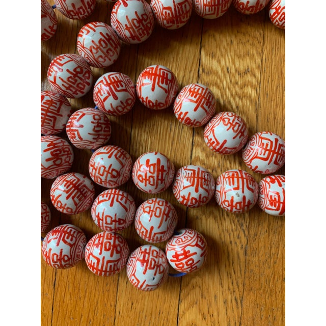 Strand of 50 hand-painted porcelain beads with "double happiness" painted on each in Chinese. Each bead: 1.5"Dia. Beads...