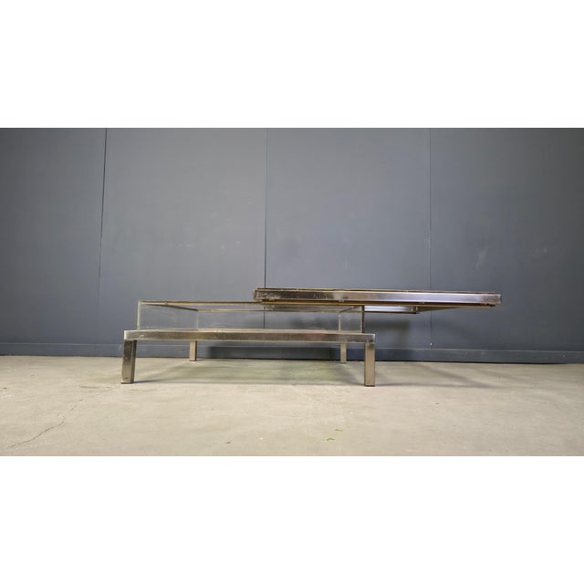 Vintage display coffee table with a sliding glass top. This luxurious coffee table is made from heavy quality polished...