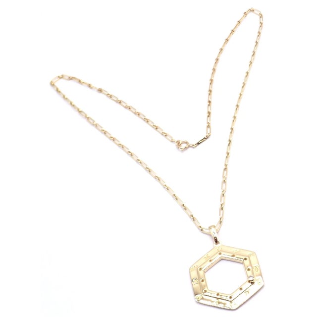 Crafted in 18k yellow gold, this vintage Cartier Zodiac pendant necklace features a distinctive hexagonal frame engraved...
