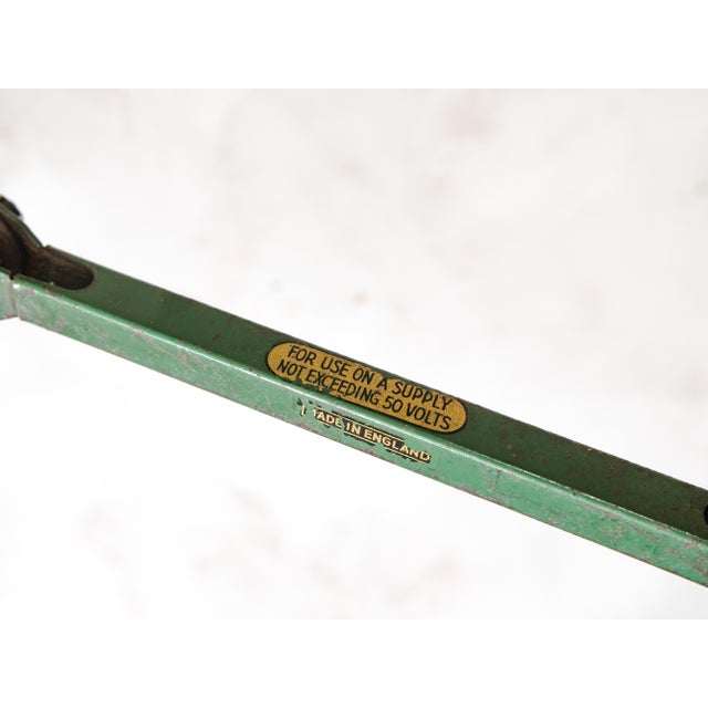 A four-arm articulated machinist lamp by e.d.l. Of staffordshire, england, in original green enamel, usable as a table...