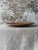 Handsome contemporary ceramic serving tray in a warm brown matte finish with softly irregular edges and a gently hand-...