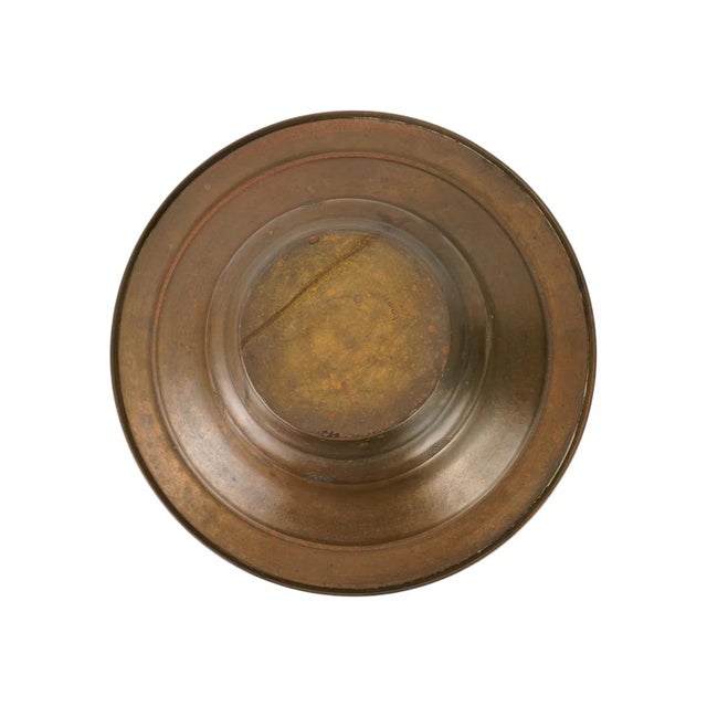 An antique Islamic brass basin, dating to the 19th century. The vessel is engraved with arabesque motifs, geometric...