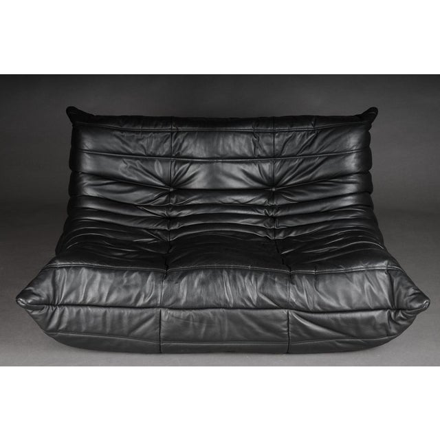 Two-seater Togo sofa, black leather by Michel Ducaroy, Ligne Roset, France, Originally designed in the 1970s, the iconic...