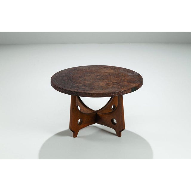 This expressive round coffee table was designed by Angel Pazmiño and produced by Muebles de Estilo in Ecuador, circa 1960....