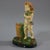 Brownfield Majolica posy holder which features a putti carrying a bunch of wheat. Stood beside a wicker basket....