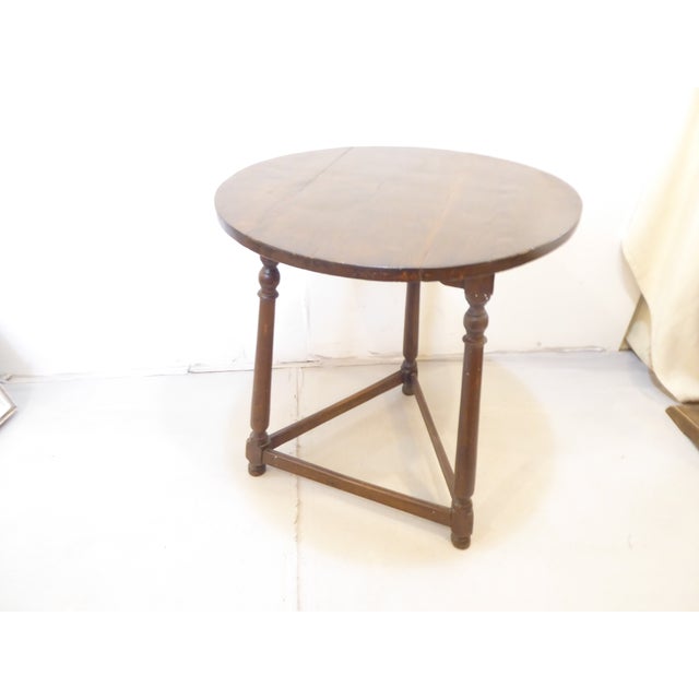 This English oak cricket table has a pegged construction and a lightly carved apron and measures 30"H x 26.5"Diameter.