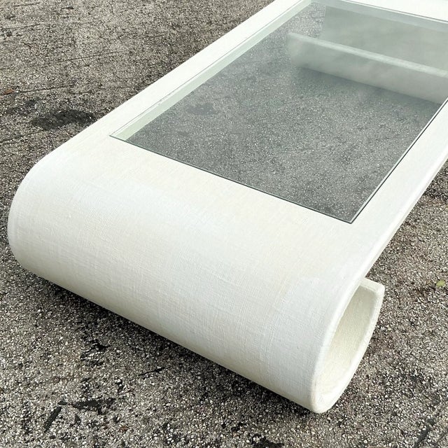 Elevate your living space with this stunning Vintage Boho Linen Wrapped Scroll Coffee Table. Featuring a unique scroll...
