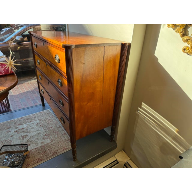 This is a 19th century Tiger maple chest of drawers. It has four drawers. It has brass hardware. It is in Sheraton style....