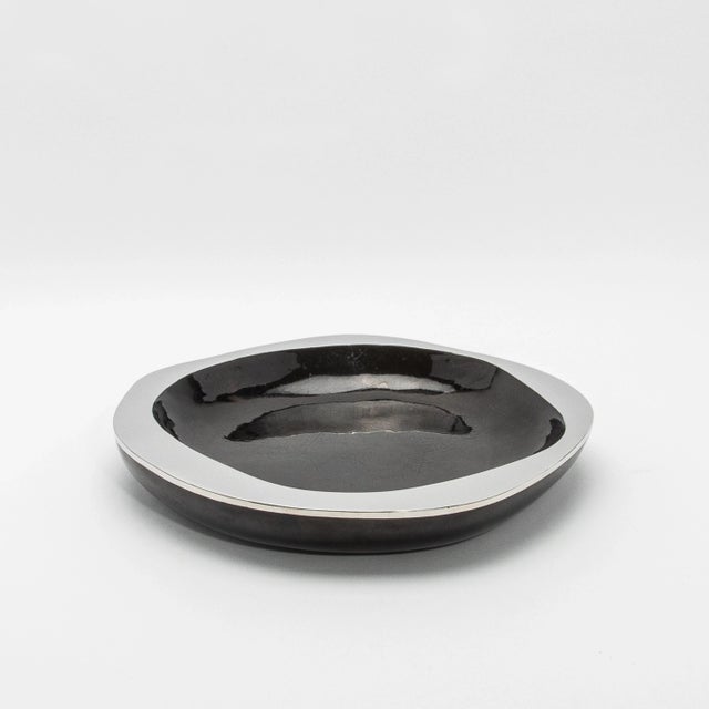 The Black Shell & Stainless-Steel Lily Bowl by R&Y Augousti is an exquisite example of refined craftsmanship. Meticulously...