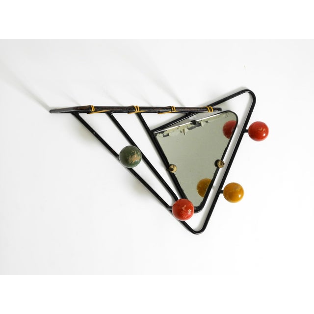 Very beautiful, rare French Mid-Century Modern wall-mounted coat rack. Frame made of black lacquered tubular steel with...