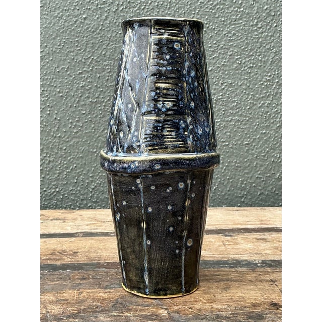 This striking vintage studio pottery vase is a masterwork of architectural form and tactile surface design. Hand-crafted...