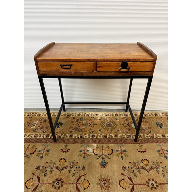 Design Plus Gallery presents a Petite Writing Desk with a Vintage + Rustic Style. The wood looks salvaged and has a medium...