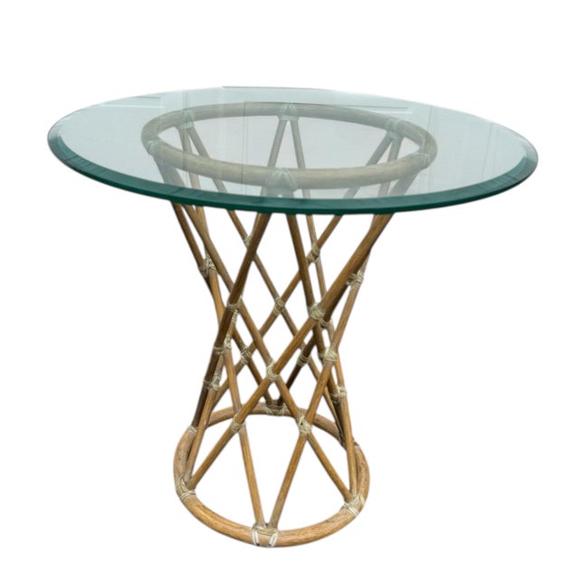 A rare twisted rattan side table from McGuire of San Francisco. Elegant and modern form, the table is fitted with a thick...