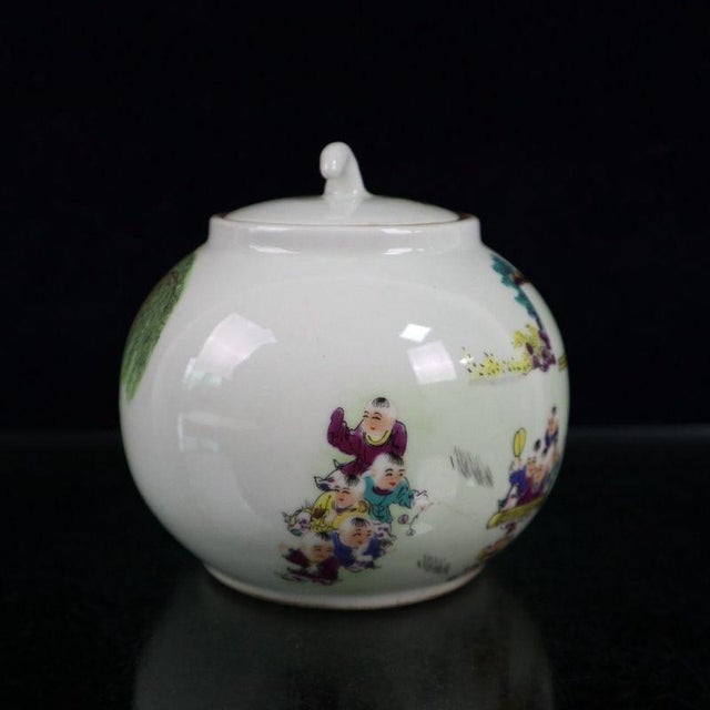 Charming Chinese famille rose lidded jar hand-painted with a lively “hundred boys” scene. Numerous children play games...