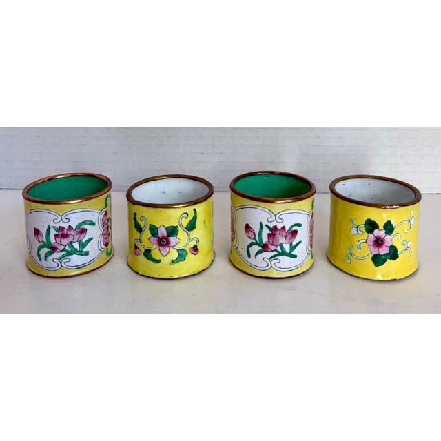 Here is a charming set of four vintage cloisonné-style napkin rings, likely made in the later mid-century. Each features a...