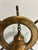Chairish Description A handsome vintage brass ship's wheel with a small bell hanging at its center, mounted on a weighty...