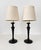 Pair of solid bronze or brass candlestick form lamps with a hammered or peened surface that and that is reminiscent of the...