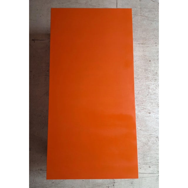 Late 20th Century lacquered coffee table rectangular with a plain surface finished in an orange color. The embellished...
