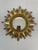 A stunning radiant resin Mid Century Modern gilded Sunburst Wall Mirror with varying lengths of rays. Circa Mid 1960s-70s....