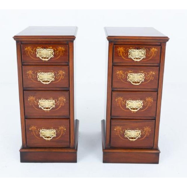 Pair of mahogany inlaid chest of drawers or bedside cabinets Each of the chests stands upon a plinth base and features 4...