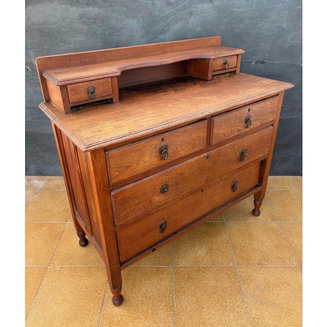 Charming chest of drawers crafted in oak, featuring a practical and elegant layout with two small upper drawers set into a...