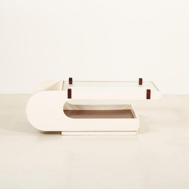 This Italian coffee table comes from the 1970s and combines a distinctive sculptural form with practical storage. Overall...