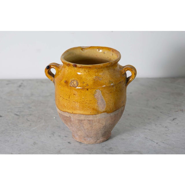 This 19th-century Spanish pottery jar is a beautiful example of rustic Mediterranean craftsmanship. Handcrafted from...