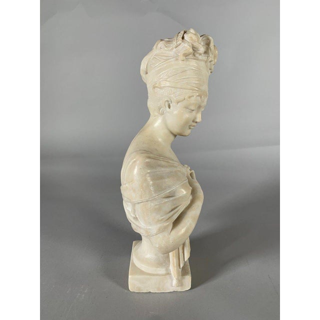 A white marble sculpture depicting a bust of Madame de Récamier after Joseph Chinard (1756-1813). Made of fine, heavy...