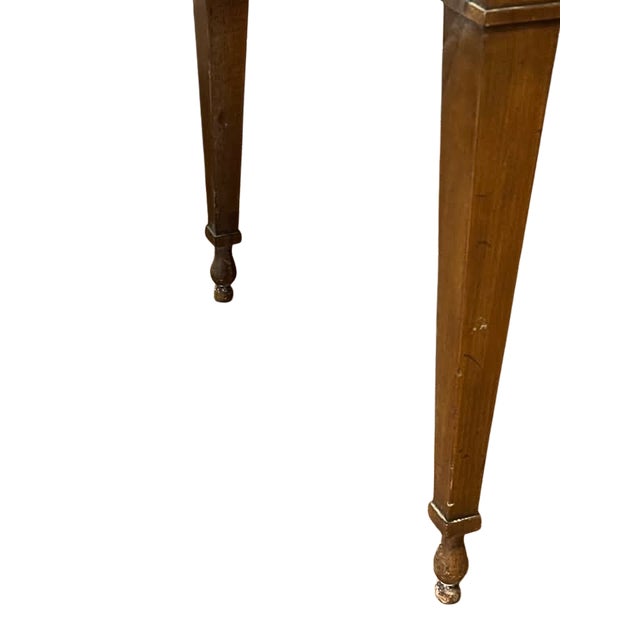 A handsome vintage walnut writing desk featuring a beautifully patterned veneer top, elegant tapered legs, and classic...