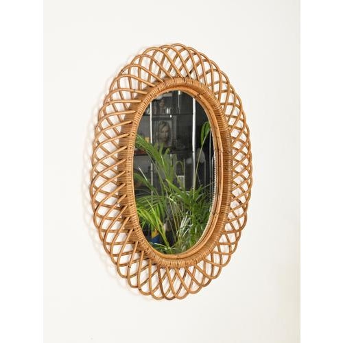 Stunning French Riviera style large oval mirror, fully made of hand-woven wicker, curved rattan, and bamboo. This elegant...