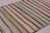 Handwoven in wool, by nomads of the Shahson clan, circa 1950-1960, this 5x8 vintage Kilim enjoying colorful stripes, is a...