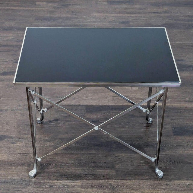 Chromed steel legs and cross stretchers with black glass top on paw feet in the "Neoclassical" style. Brand: Ralph Lauren....