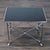 Chromed steel legs and cross stretchers with black glass top on paw feet in the "Neoclassical" style. Brand: Ralph Lauren....