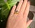 A stylish vintage double band ring in 18-carat yellow gold (750/1000), featuring two natural oval-shaped sapphires—one...