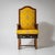 Armchair with high curved backrest, yellow upholstery with floral ornaments, and a straight wooden frame with H-shaped...