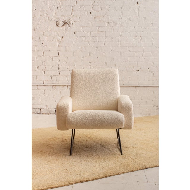 A mid century armchair attributed to Geneviève Dangles and Christian Defrance. Iron base and new wool bouclé upholstery....