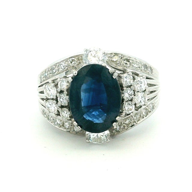 A dramatic and beautifully crafted platinum ring centered by a GIA-certified natural blue sapphire weighing 4.33 carats....