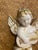 A beautifully detailed vintage cherub angel figurine featuring a sweet angel playing a guitar, with soft gold accents...