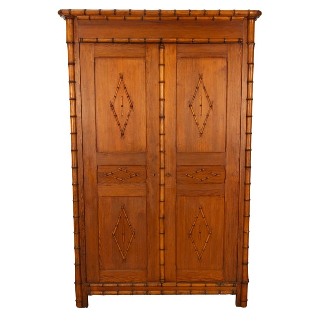 A fine quality antique 19th century French faux bamboo pine wardrobe/armoire, circa 1880. The armoire is made of finely...