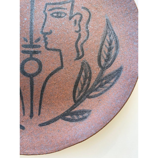Slab built ceramic platter made from Death Valley speckled clay. Design in manner of Jean Cocteau painted in black...