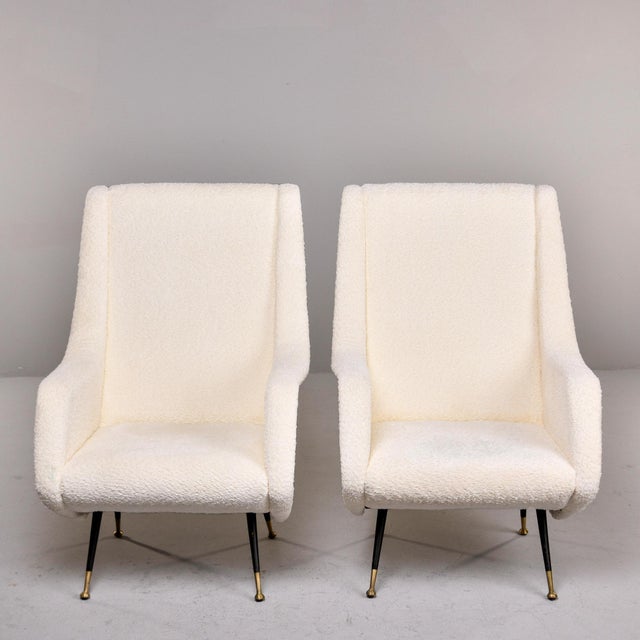 Found in Italy, this pair of lounge chairs dates from the 1950s. Fun, sculptural lines with high back rests, curvy sides...