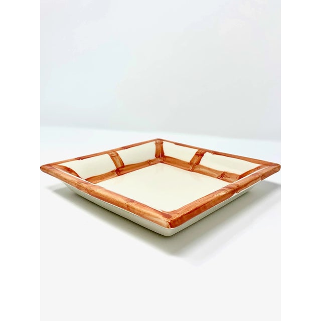 Elevate your everyday with this versatile square catchall tray, framed in a classic bamboo fret motif. Handcrafted in...
