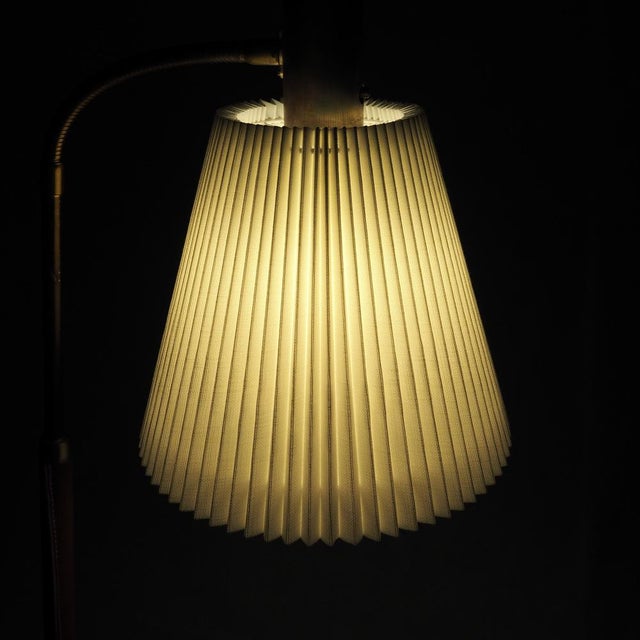 Swedish floor lamp by Falkenbergs Belysning, produced in the 1960s. Executed in brass with a leather-wrapped stem, the...